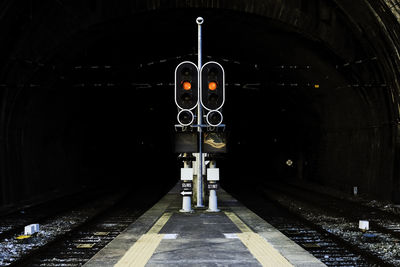 Train at railroad station platform at night