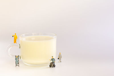 Close-up of drink in glass against white background