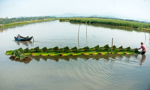 People in boat on lake