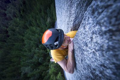 Man struggling lead climbing in off-width climb on granite squamish