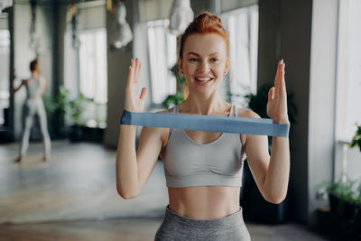 Portrait of smiling woman exercising at gym