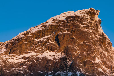 Low angle view of mountain against clear sky