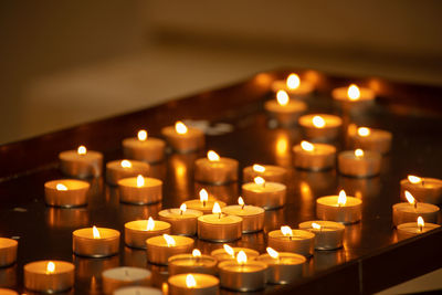 Close-up of illuminated tea light candles