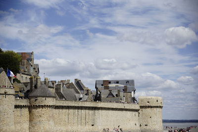 Buildings against cloudy sky