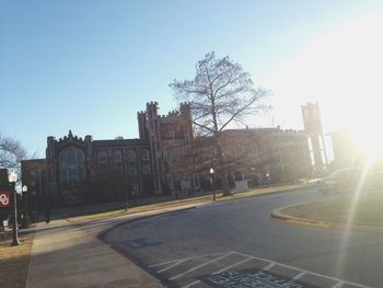 Road along buildings at sunset