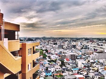 Cityscape against cloudy sky