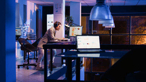 Young woman using laptop at table