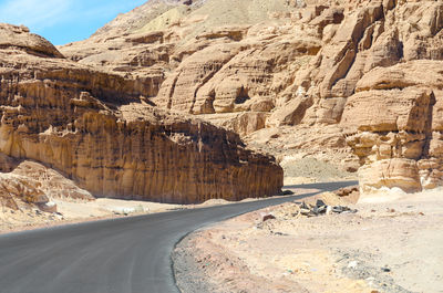 Road leading towards rock formation