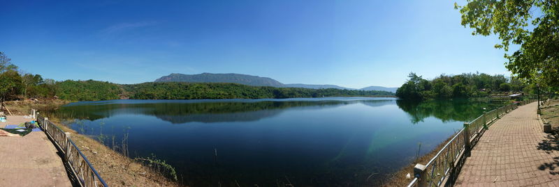 Panoramic view of lake against clear blue sky