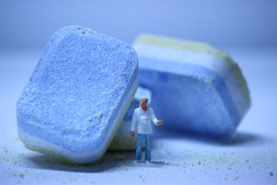 Close-up of soap and figurine on table