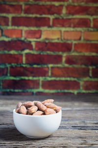 Close-up of salted almonds in bowl on table
