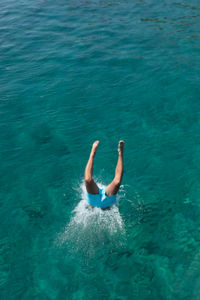 Low section of man diving into sea