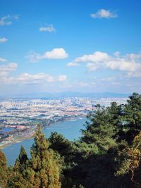 High angle view of buildings and sea against sky