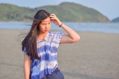 Young woman standing at beach