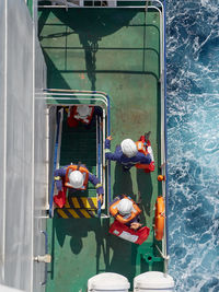 Abandoned ship drills in open sea on the vessel. four persons preparing to leave the ship.
