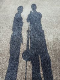 Shadow of people on road