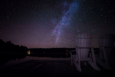 Scenic view of lake against star field at night