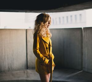 Woman standing against wall