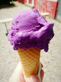 Close-up of hand holding ice cream cone