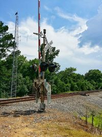 Railroad tracks by trees against sky