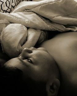 Close-up of baby resting on bed