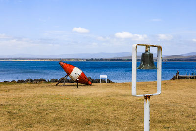 Bouy on beach against sky