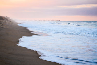 Scenic view of beach against sky during sunset