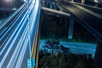 Light trails on bridge in city at night