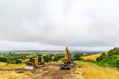 Construction machinery. bulldozer and excavator are clearing construction site.