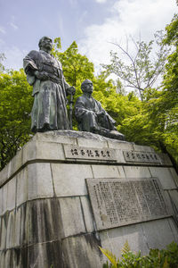 Low angle view of statue against sky