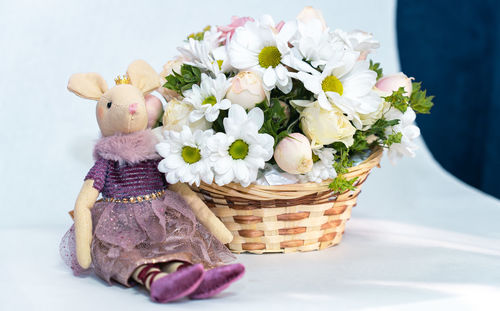 Close-up of fresh white flowers in basket on table