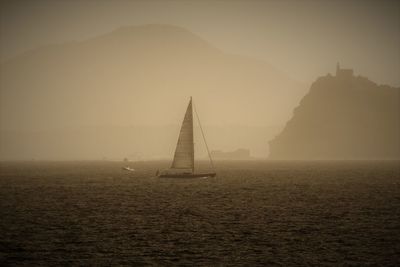 Sailboat on sea against sky