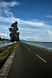 Road by sea against sky