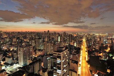 High angle view of illuminated buildings against sky at night