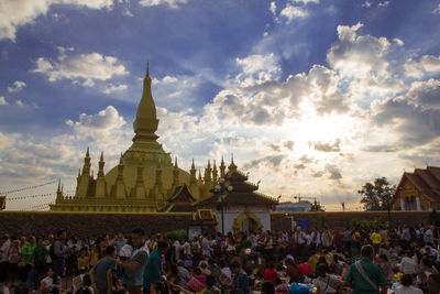 Group of people in front of building against sky