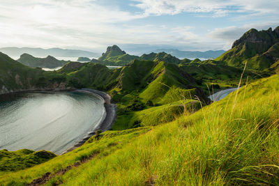 View of green-capped mountains of padar island