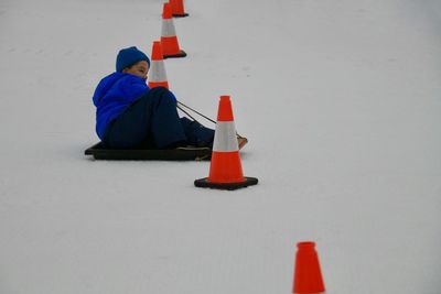 Man with red umbrella on snow