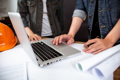 Midsection of man using mobile phone