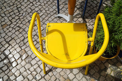 Close-up of yellow umbrella on street