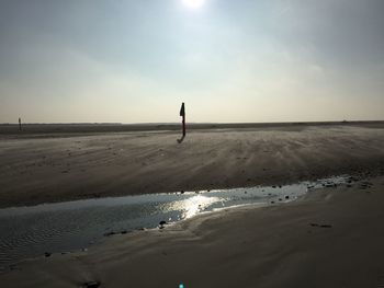 Scenic view of beach against sky during sunset