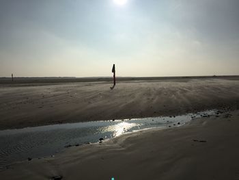 Scenic view of beach against sky during sunset