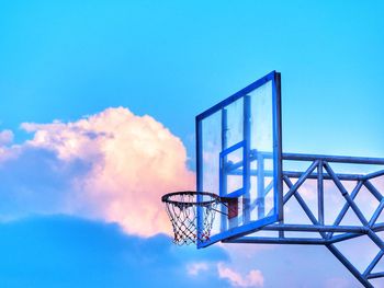 Low angle view of basketball hoop against blue sky