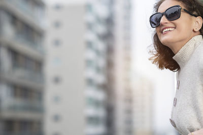 Classic beauty mid age caucasian woman wearing sunglasses and elegant clothes in the city.