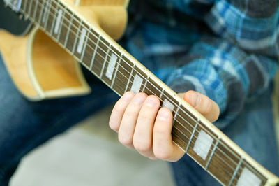 Close-up of man playing guitar