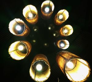 Low angle view of illuminated lighting equipment on ceiling