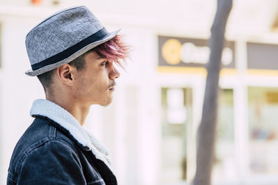 Portrait of man wearing hat looking away