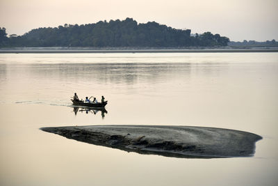 Boat on lake against sky