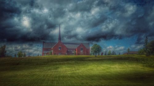 Houses on field against sky