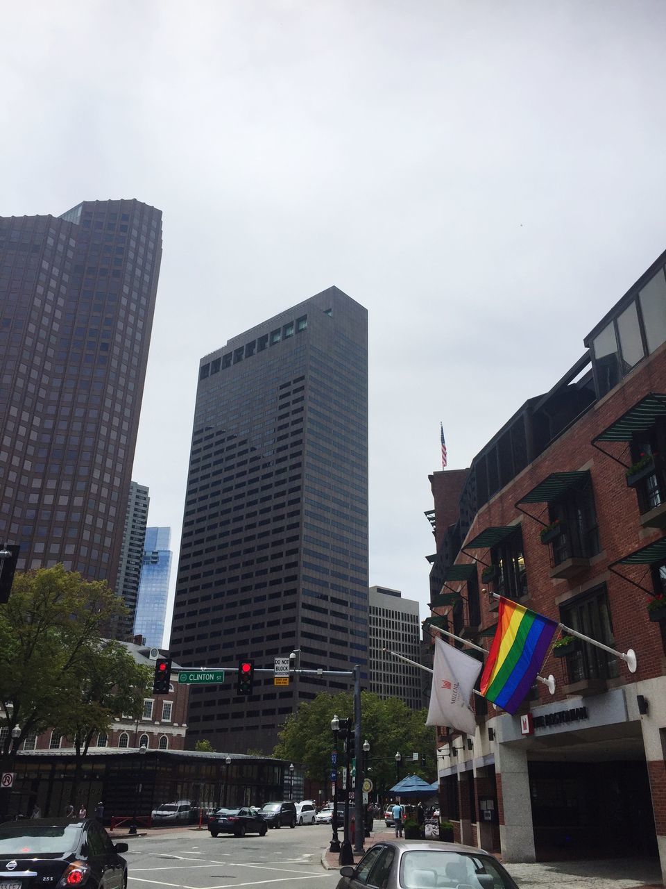 flag, architecture, building exterior, built structure, city, sky, car, outdoors, patriotism, day, skyscraper, no people