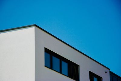 Low angle view of building against clear blue sky